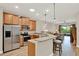 The modern kitchen features stainless steel appliances, granite counters, and a breakfast bar with seating at 3210 Sonesta Ct # B, Clermont, FL 34711