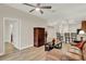 The open living area connects to the kitchen and dining area and features a ceiling fan and tile floors at 3210 Sonesta Ct # B, Clermont, FL 34711