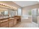 Spacious bathroom features soaking tub, glass shower, double sinks and tile floor at 3808 Ocita Dr, Orlando, FL 32837