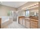 Bathroom features a soaking tub, glass shower, double sinks, and tile floor at 3808 Ocita Dr, Orlando, FL 32837