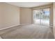 Bedroom showcasing carpet flooring and sliding glass doors opening to a screened-in patio and pool at 3808 Ocita Dr, Orlando, FL 32837
