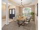Bright dining room with a modern table, six chairs, a chandelier, and natural light from a large window at 3808 Ocita Dr, Orlando, FL 32837