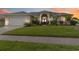 Charming home featuring a beautifully landscaped front yard, arched entryway, and a two-car garage at 3808 Ocita Dr, Orlando, FL 32837