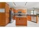 Well-equipped kitchen with stainless steel appliances, granite countertops, an island, and ample cabinet space at 3808 Ocita Dr, Orlando, FL 32837