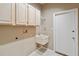 Laundry room features upper cabinets, sink, and white tile floor at 3808 Ocita Dr, Orlando, FL 32837