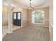 Open living room showcases a large window, neutral walls, with columns and a chandelier highlighting the room's design at 3808 Ocita Dr, Orlando, FL 32837