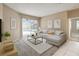 Relaxing living room with a comfortable sofa, modern decor, a ceiling fan, and access to the outdoor pool area at 3808 Ocita Dr, Orlando, FL 32837
