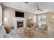 Cozy living room with a fireplace, comfortable seating, a ceiling fan, and a view of the pool area at 3808 Ocita Dr, Orlando, FL 32837