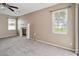 A bright living room features a fireplace, ceiling fan, and natural light through windows at 3808 Ocita Dr, Orlando, FL 32837