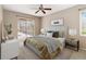Serene main bedroom with a cozy bed, soft lighting, a ceiling fan, and sliding glass doors to the pool area at 3808 Ocita Dr, Orlando, FL 32837