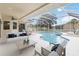 Inviting screened-in pool area with comfortable seating, an outdoor dining set, and a clear blue pool at 3808 Ocita Dr, Orlando, FL 32837
