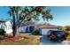 Well-maintained home with a spacious front yard, mature tree, and a two-car garage at 3917 Derby Dr, Lakeland, FL 33809
