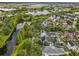 Aerial view of a neighborhood including a lake, green landscaping, and many homes at 4545 Fox St, Orlando, FL 32814