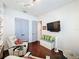 Cozy bedroom features a wall-mounted TV and modern gray doors at 4545 Fox St, Orlando, FL 32814