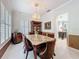 Formal dining room with a chandelier, brown velvet dining chairs, and views of the front foyer at 4545 Fox St, Orlando, FL 32814