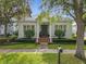 Lovely home exterior featuring manicured landscaping, classic architectural details, and a welcoming front entrance under a clear blue sky at 4545 Fox St, Orlando, FL 32814