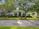 Beautifully landscaped home exterior featuring manicured greenery, stately trees, and a charming facade under a bright, sunny sky at 4545 Fox St, Orlando, FL 32814