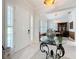 Bright and airy foyer featuring elegant tile flooring, shuttered windows, and an elaborate table with a mirrored top at 4545 Fox St, Orlando, FL 32814