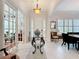 Bright foyer with white shutters, marble floors, an elegant light fixture, and clear view to the sitting and dining rooms at 4545 Fox St, Orlando, FL 32814