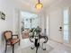 Elegant foyer with marble floors, a decorative table, and a view into the spacious living area with built-in bookshelves at 4545 Fox St, Orlando, FL 32814