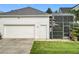 Attached garage and screened-in patio offer convenience and outdoor enjoyment at 4545 Fox St, Orlando, FL 32814