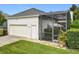 Attached garage and screened-in patio offer convenience and outdoor enjoyment at 4545 Fox St, Orlando, FL 32814