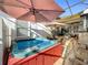 Covered hot tub area with outdoor furniture and partially shaded patio at 4545 Fox St, Orlando, FL 32814