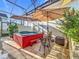 Screened-in patio featuring a red hot tub, outdoor seating, and garden area at 4545 Fox St, Orlando, FL 32814
