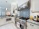Gourmet kitchen features a high-end stainless steel stove and custom backsplash at 4545 Fox St, Orlando, FL 32814