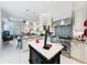 Spacious kitchen with island, stainless steel appliances, and open concept living area at 4545 Fox St, Orlando, FL 32814