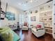 Cozy living room featuring dark floors, built in shelves and comfortable seating at 4545 Fox St, Orlando, FL 32814