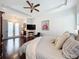 Bright main bedroom featuring a ceiling fan, private access to the outside and gleaming hardwood floors at 4545 Fox St, Orlando, FL 32814