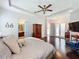 Spacious main bedroom with dark floors and neutral wall colors, with an ensuite bathroom at 4545 Fox St, Orlando, FL 32814