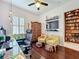 Comfortable office area with a built in shelf, wood floors and comfortable accent chairs at 4545 Fox St, Orlando, FL 32814