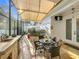 Relaxing covered patio with a modern outdoor kitchen and shaded dining area at 4545 Fox St, Orlando, FL 32814