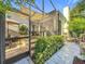 Partially shaded patio with outdoor kitchen, hot tub, and screened-in area at 4545 Fox St, Orlando, FL 32814