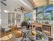 Covered patio boasts an outdoor kitchen, comfortable seating, and ceiling fan at 4545 Fox St, Orlando, FL 32814