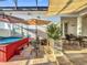 Outdoor space features a hot tub and patio seating with market umbrellas at 4545 Fox St, Orlando, FL 32814