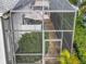 View of screened-in lanai area featuring well-kept greenery and access to the outside via a secured door at 4545 Fox St, Orlando, FL 32814