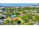Aerial view of a neighborhood with a ballpark, tennis courts, and a cityscape at 501 Richmond St, Orlando, FL 32806