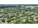 Enjoy scenic aerial view of tree-lined neighborhood, complete with a lake and sports fields at 501 Richmond St, Orlando, FL 32806