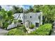 Backyard view of a two-story home featuring lush landscaping and a brick patio with outdoor seating at 501 Richmond St, Orlando, FL 32806