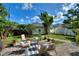 Landscaped backyard features a brick patio with an outdoor seating area, creating a relaxing space for entertaining at 501 Richmond St, Orlando, FL 32806