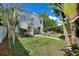 The backyard is a beautiful place to relax, with a patio that has seating and lush landscaping at 501 Richmond St, Orlando, FL 32806
