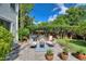 Cozy backyard patio with comfortable seating, potted plants, and well-maintained hedges at 501 Richmond St, Orlando, FL 32806
