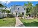 Charming backyard featuring a brick path, lush lawn, and an inviting patio with outdoor seating at 501 Richmond St, Orlando, FL 32806