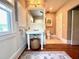 Traditional bathroom with beadboard paneling, pedestal sink, and mosaic floors at 501 Richmond St, Orlando, FL 32806