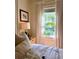Comfortable bedroom featuring two windows and a wooden nightstand at 501 Richmond St, Orlando, FL 32806