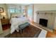 Cozy bedroom featuring a brick fireplace, hardwood floors, and natural light at 501 Richmond St, Orlando, FL 32806