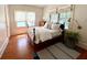 Inviting bedroom with hardwood floors, two windows, and a comfortable bed at 501 Richmond St, Orlando, FL 32806